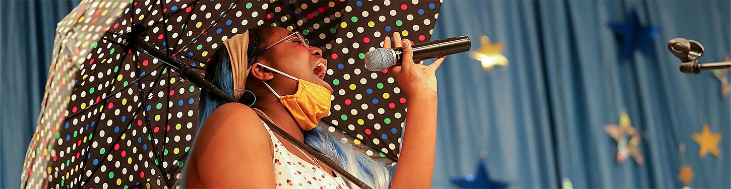 a student sings at a talent show